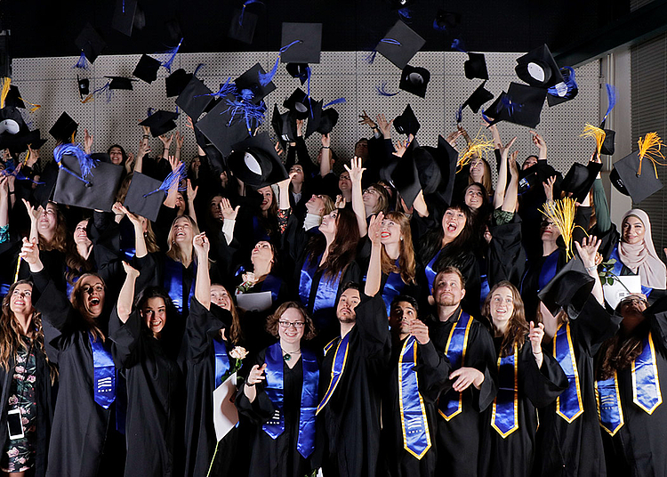 To the top: Our new graduates throw their mortarboards.