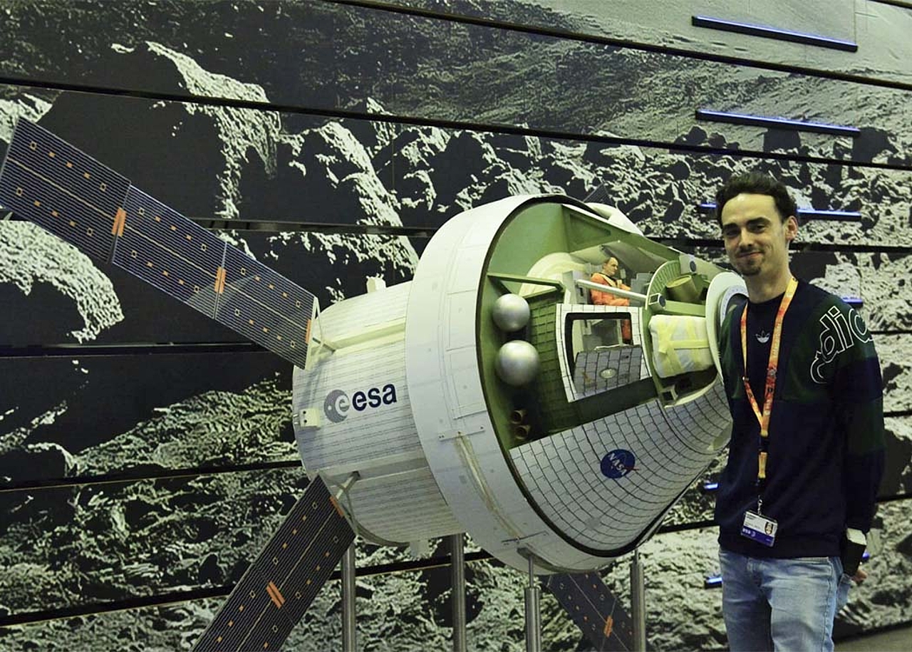 Lorenzo Cervantes vor einem Modell der Orion-Kapsel, die im Rahmen des Artemis-Programms voraussichtlich die nächsten Menschen auf den Mond fliegen wird.